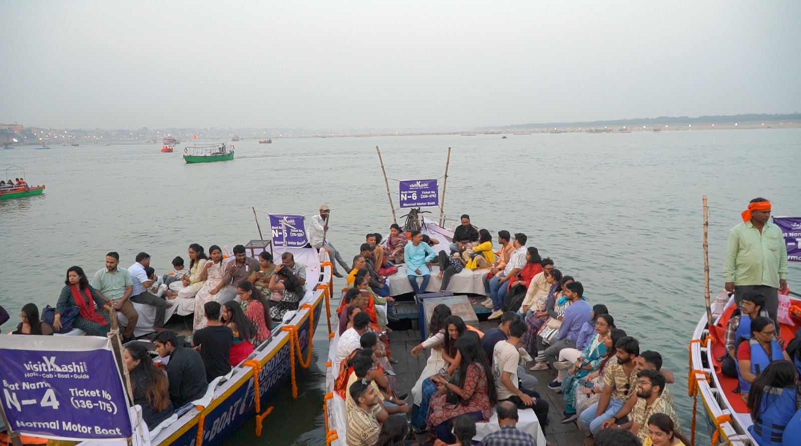 Groups seated on Visit Kashi boats for Dev Diwali in Varanasi